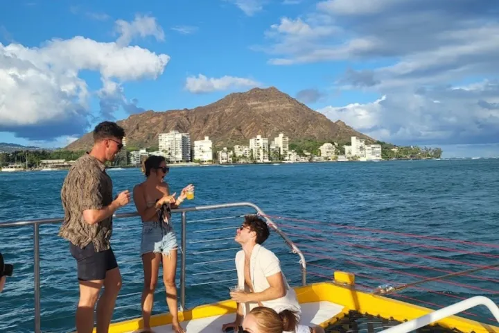 a group of people standing next to a body of water