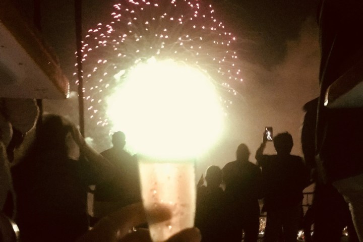 a man standing in front of a crowd of people in a dark room